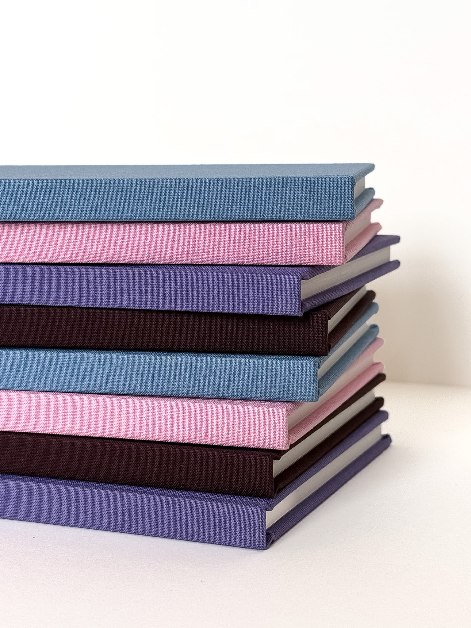 Stack of colourful Doha Lines notebooks
